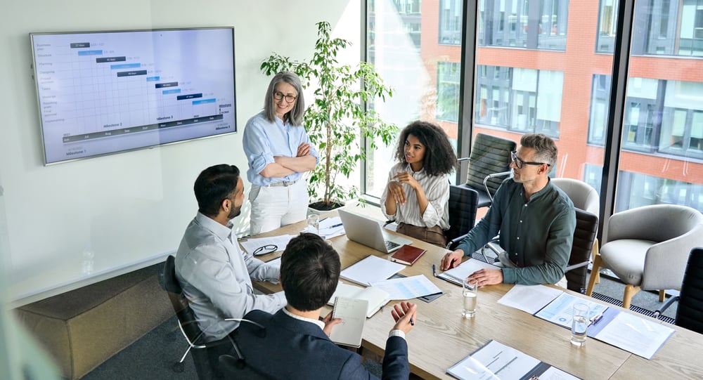 Diverse corporate team working together in modern meeting room office